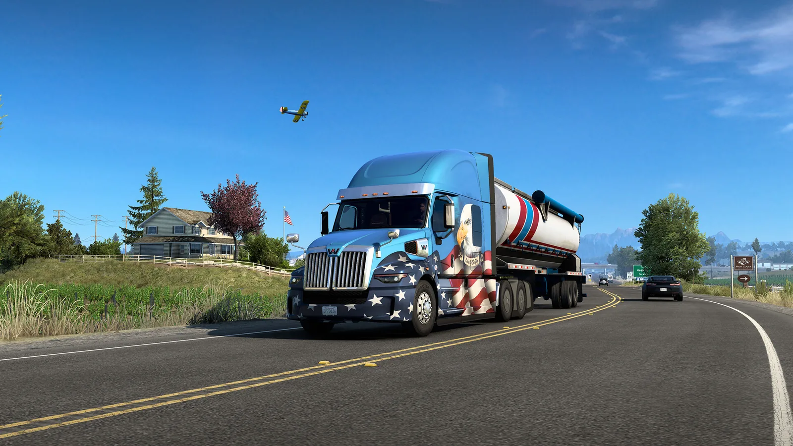 Caminhão convencional americano puxando um tanque em rodovia aberta no American Truck Simulator.